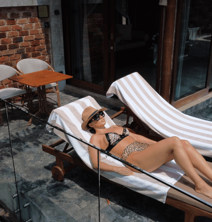Guest relaxes on a lounge chair at the private pool villa in Aarunya Nature Resort