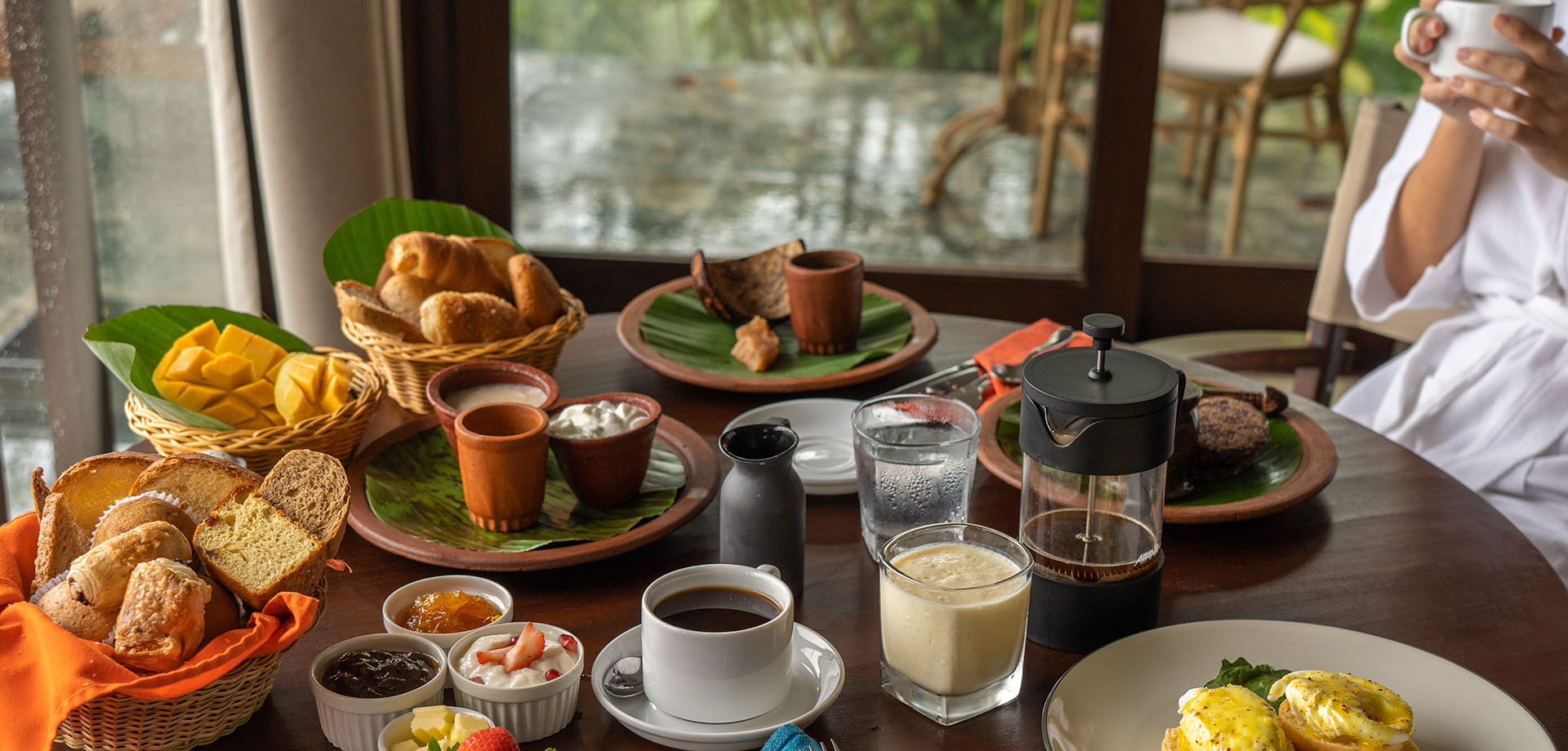 Guest enjoying delicious breakfast spread at Aarunya Nature Resort