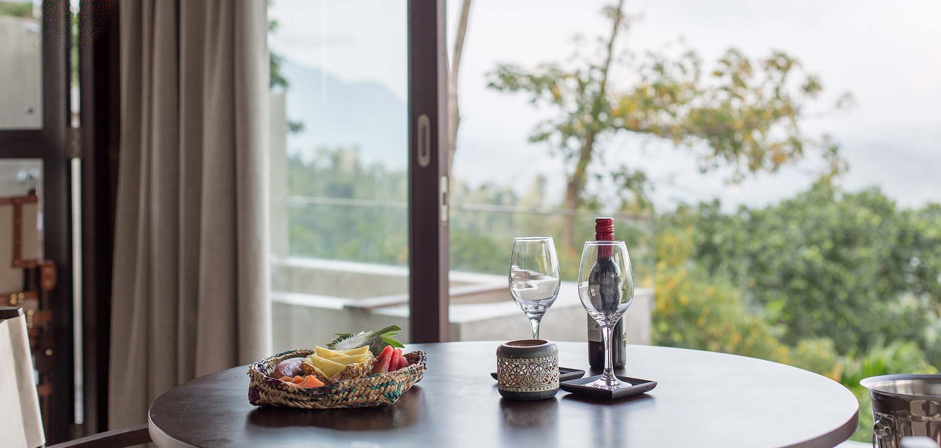 Dining setup with welcome wine and scenic views at Aarunya Nature Resort
