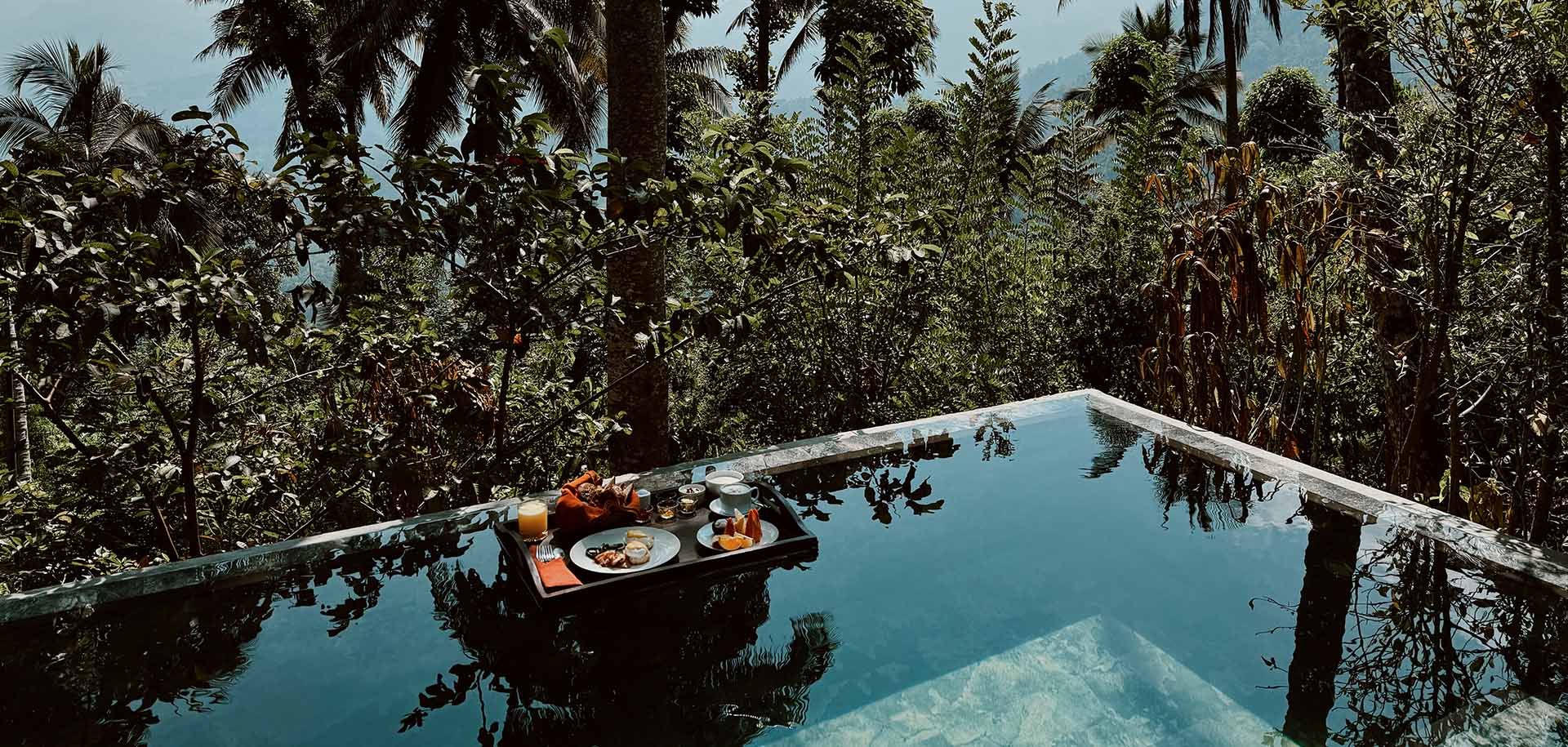 Floating food platter in the pool of a villa at Aarunya Nature Resort