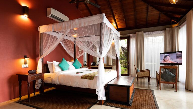 Comfort king size bed and modern amenities at Aarunya Nature Resort