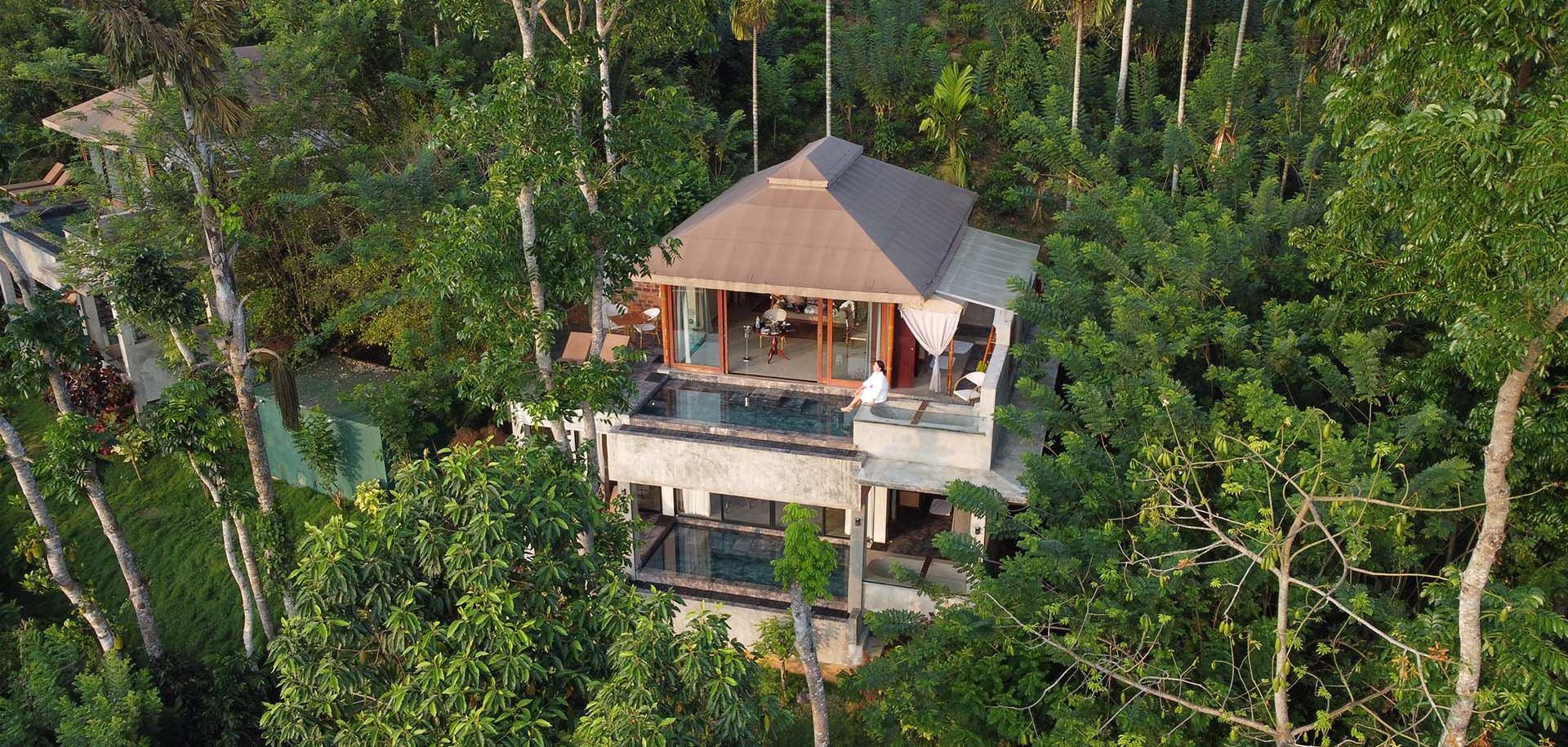 Far shot of guest enjoying the view from a villa at Aarunya