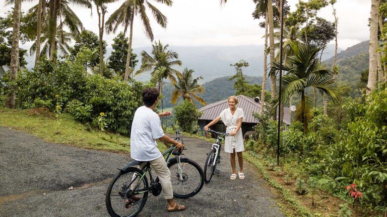 Couple getting ready to cycle through Aarunya Resort's scenic hills