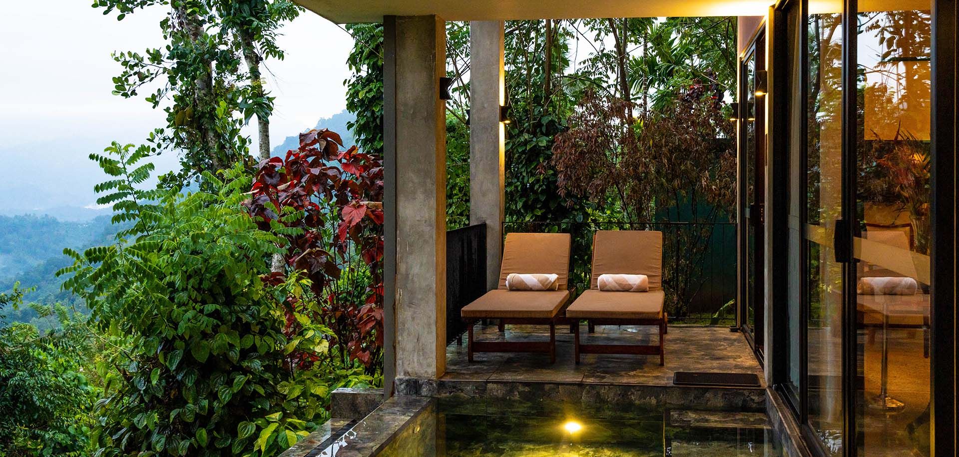 Outdoor pool with sun loungers at Aarunya Nature Resort Villa