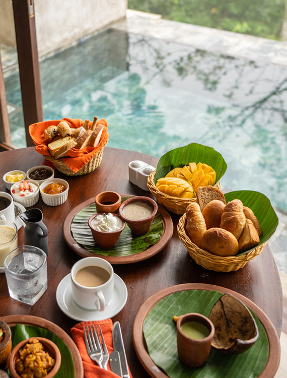 Tropical breakfast spread by the pool at Aarunya Nature Resort