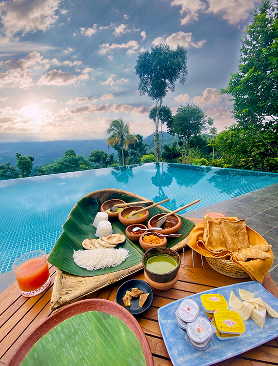 Sri Lankan breakfast served by the pool with local flavors at Aarunya Nature Resort