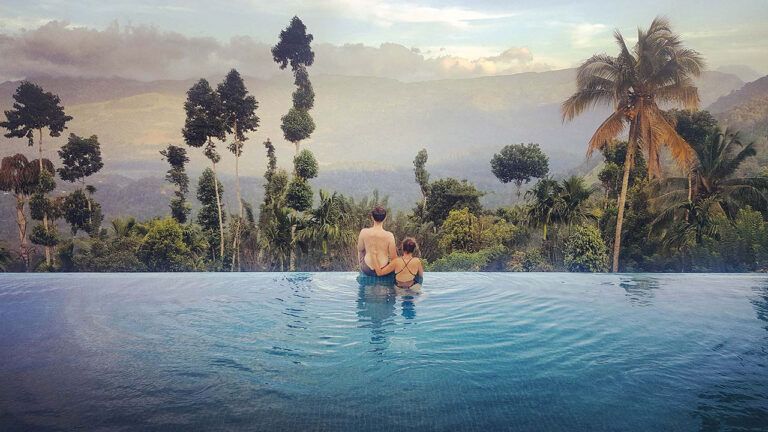 Couple enjoying nature views from the infinity pool at Aarunya Nature Resort