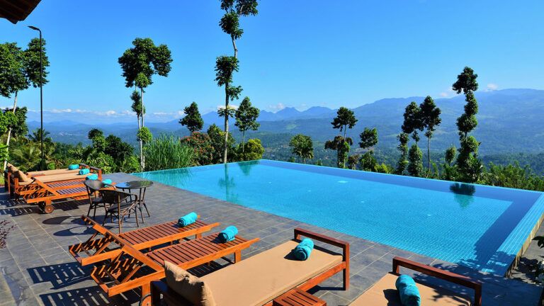 Pool with scenic views and loungers at Aarunya Nature Resort