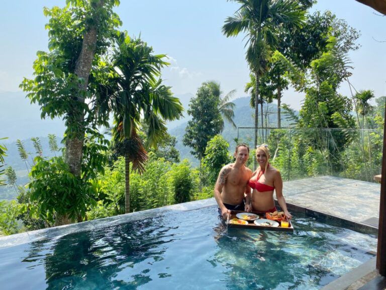 Couple having a floating breakfast in the pool with scenic views at Aarunya