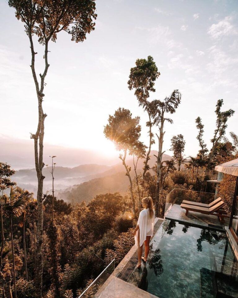 Guest enjoying scenery from edge of the infinity pool at Aarunya