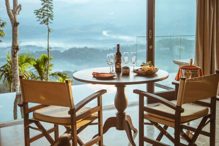 Dining setup with welcome wine and scenic view at Aarunya Nature Resort