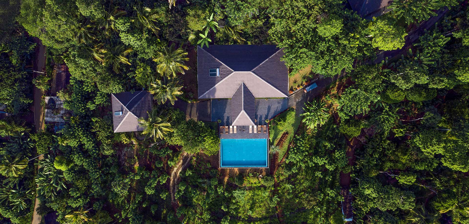 Aerial shot of Aarunya Nature Resort, surrounded by lush landscapes