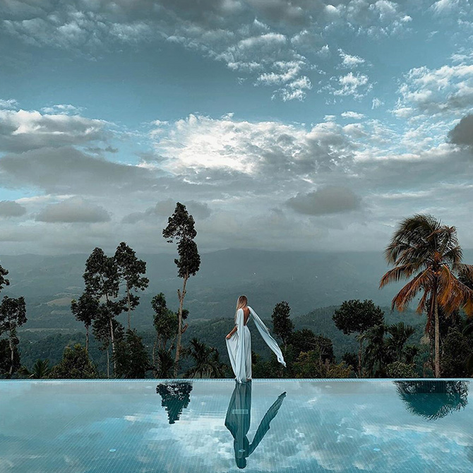 Guest enjoying scenery from edge of the infinity pool at Aarunya
