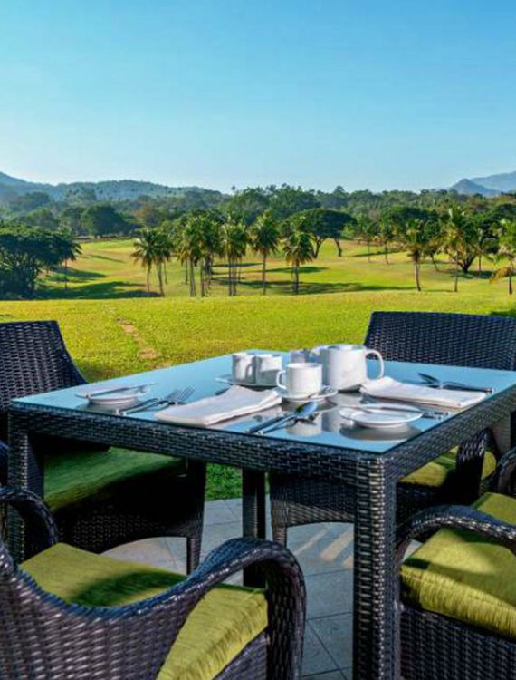 Tea setup on a dining table with a scenic backdrop at Victoria Golf Club