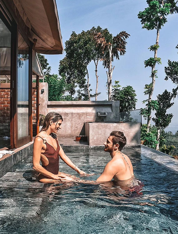 Couple enjoying a romantic moment in the pool at Aarunya Nature Resort