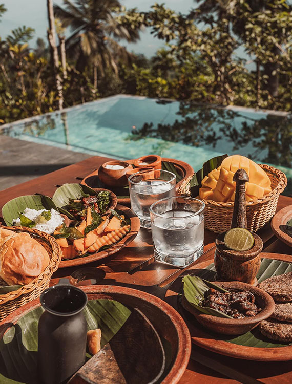 Exquisite breakfast spread by the poolside at Aarunya Nature Resort