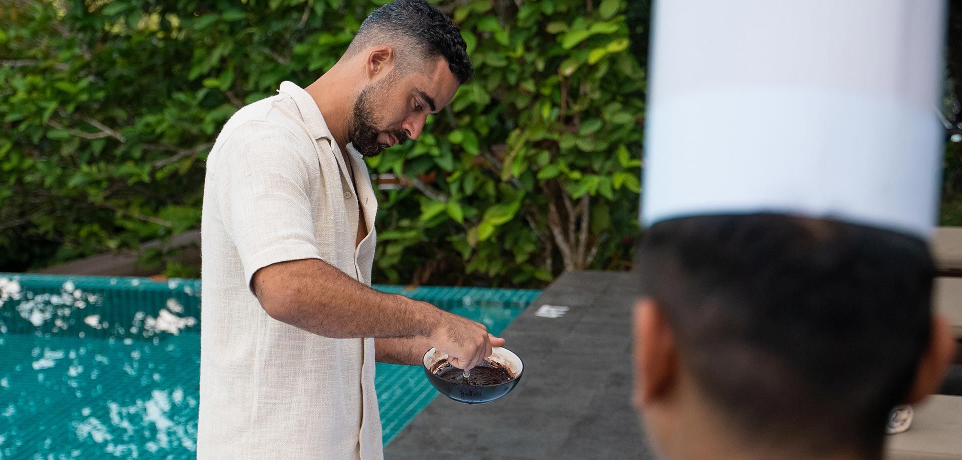 Guest making chocolate by the pool at Aarunya Nature Resort