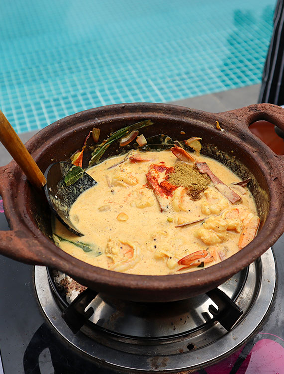 Traditional Sri Lankan curry cooking by the pool at Aarunya Nature Resort