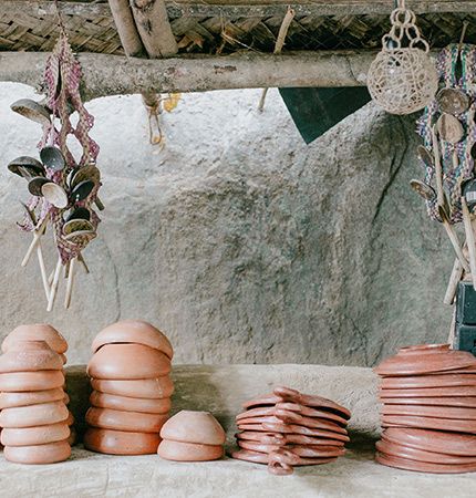 Traditional Sri Lankan kitchen items laid out on a stone ledge