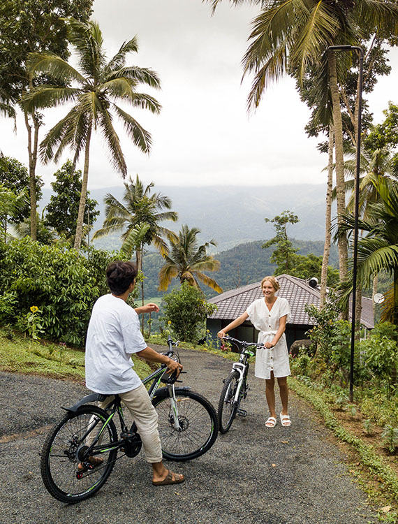 Couple getting ready to cycle through Aarunya Resort's scenic hills