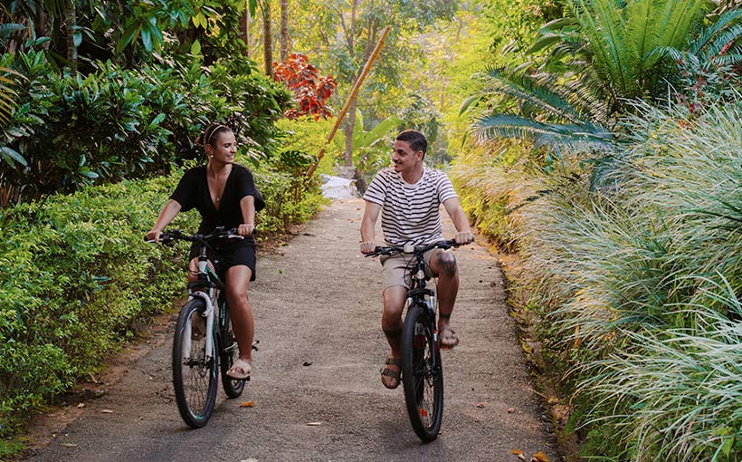 Couple cycling on a scenic trail in the hill country, Sri Lanka