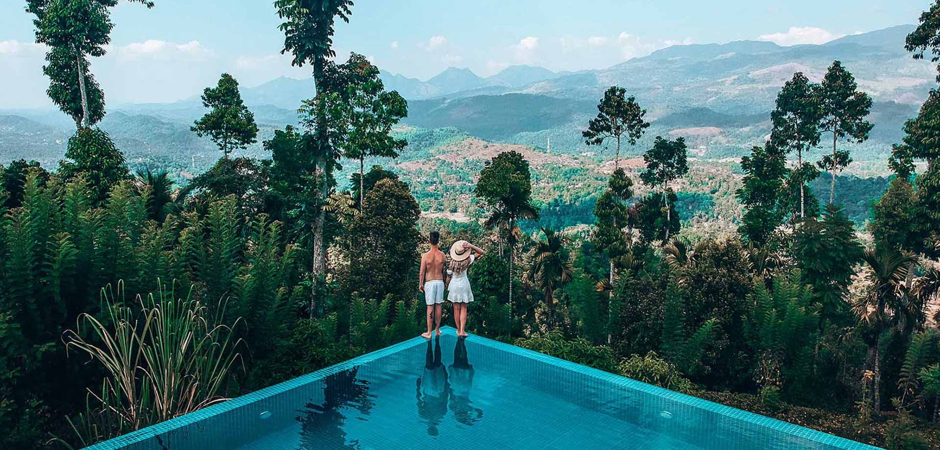 Couple enjoying scenery from edge of the infinity pool at Aarunya