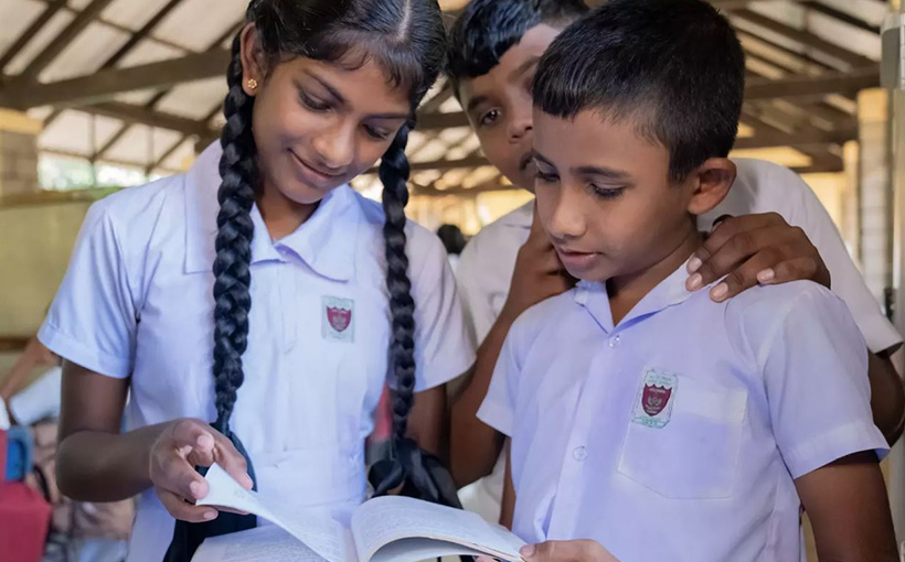 Children reading a book together