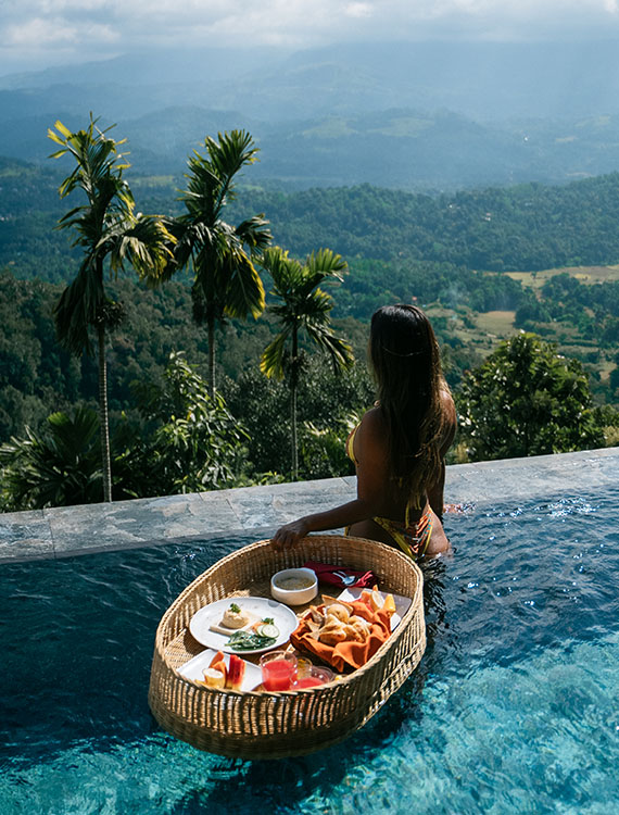 Guest with a floating breakfast, enjoying nature views at Aarunya Nature Resort