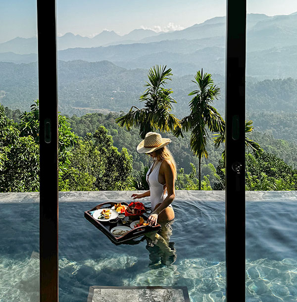 Guest enjoying floating breakfast in the pool at Aarunya Resort
