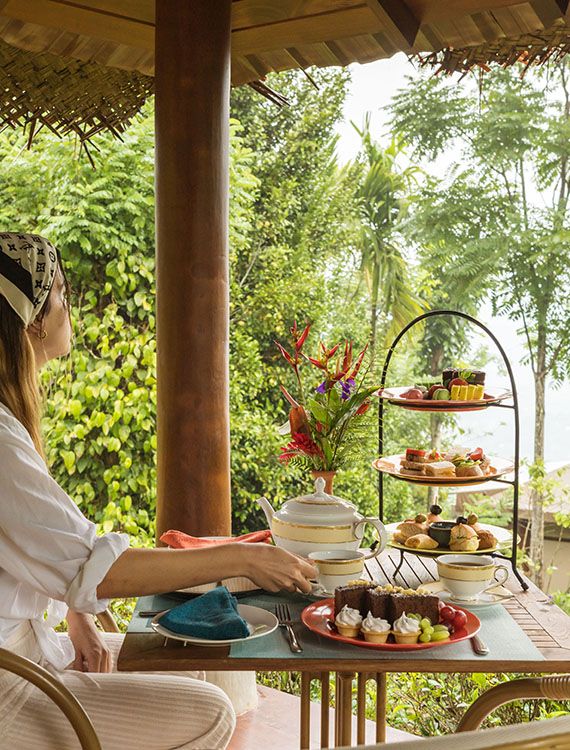 Guest enjoying Ceylon tea and high tea while taking in nature views