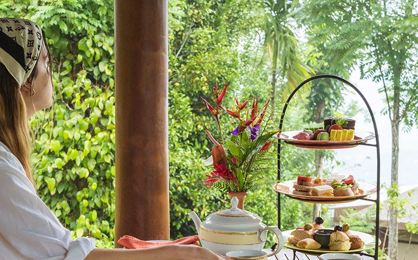 Guest enjoying Ceylon tea and high tea while taking in nature views