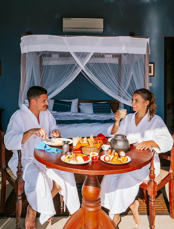 Couple enjoying an in-room dining experience at the Aarunya Nature Resort Villa