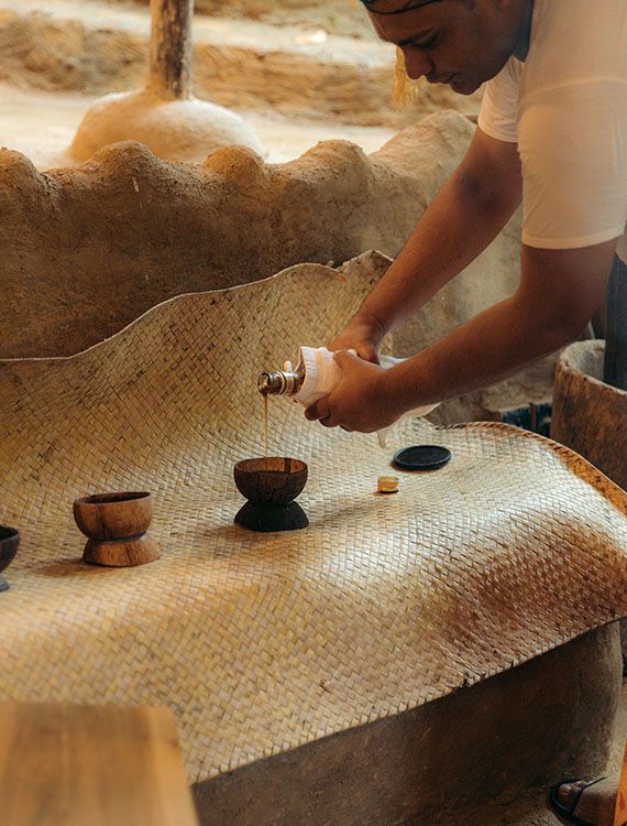 Pouring kithul treacle into coconut shell cups at Aarunya Nature Resort