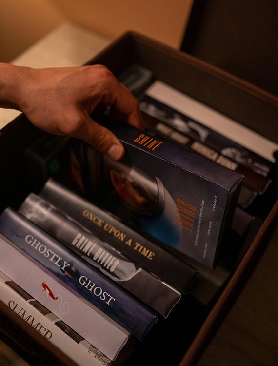 Guest browsing movie collection at Aarunya Nature Resort