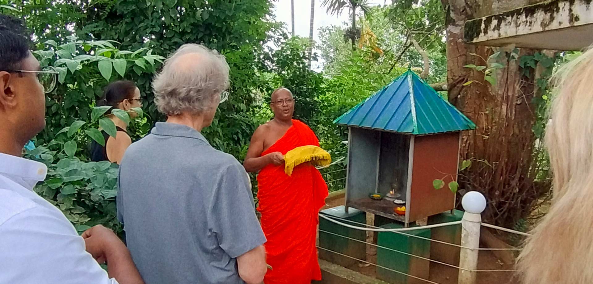 Guests in a blessing ceremony with a Buddhist monk at Aarunya's Village Temple