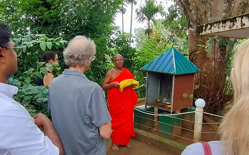 Guests in a blessing ceremony with a Buddhist monk at Aarunya's Village Temple