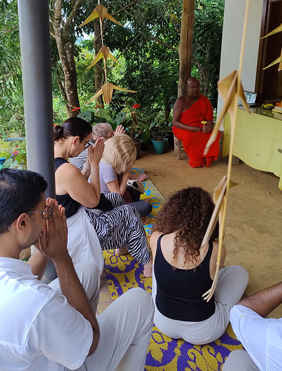 Guests worshipping during blessing ceremony at Aarunya's Village Temple