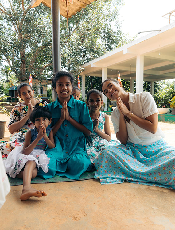 Village children and a guest worshipping together at Aarunya's Village Temple